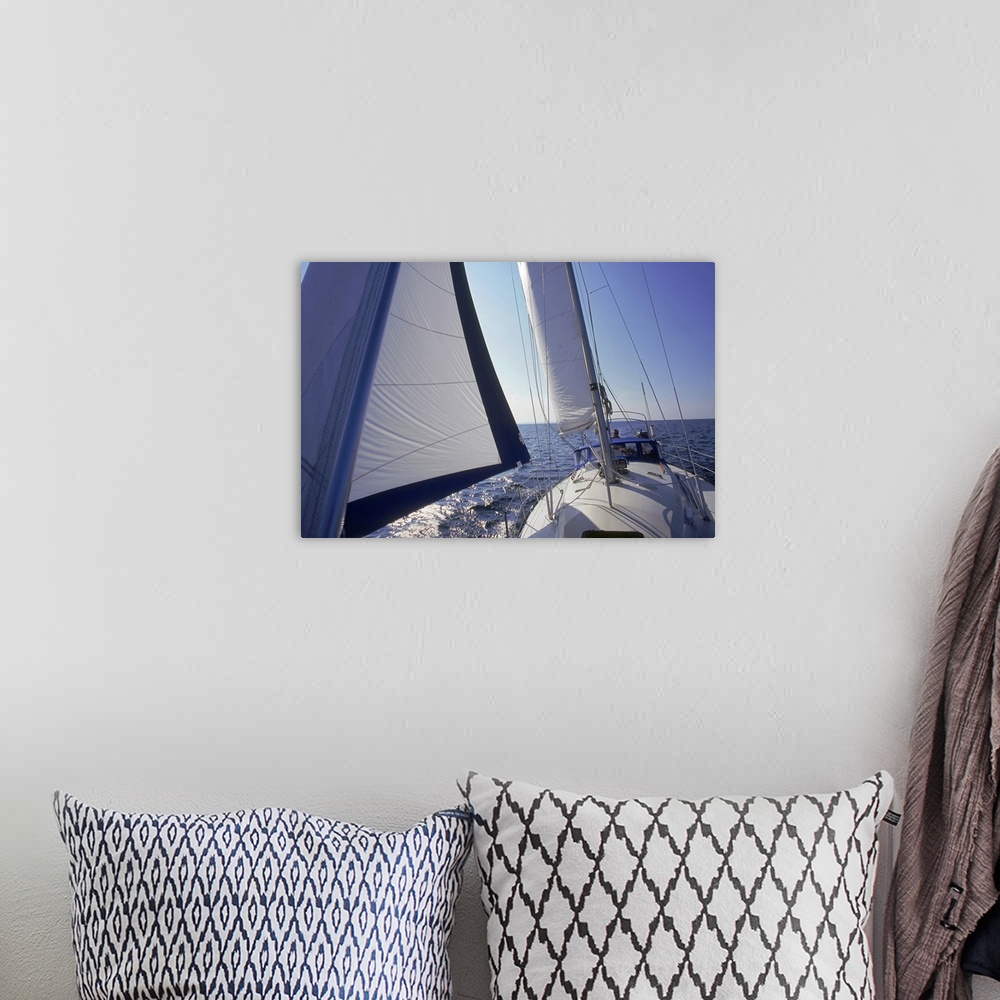 A bohemian room featuring Up-close photograph of sail on a boat with ocean in the distance under a clear sky.