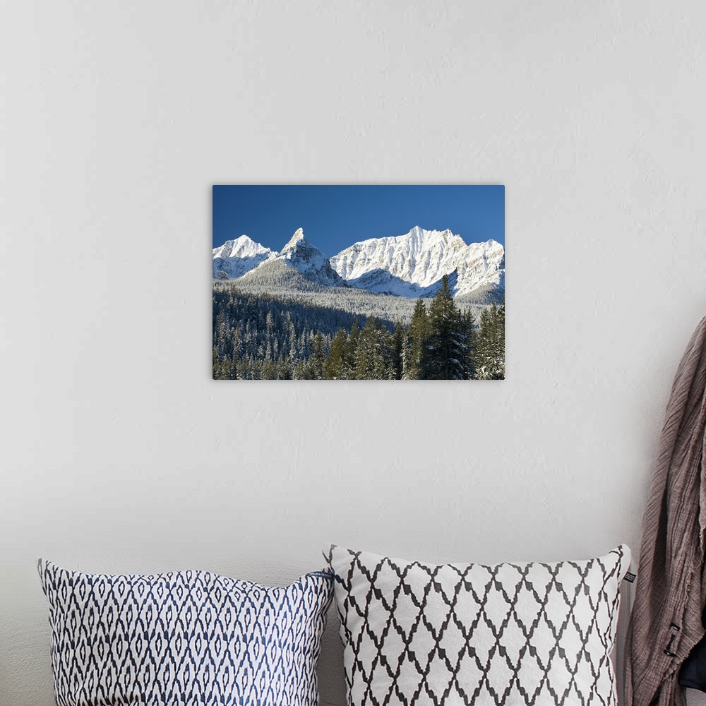 A bohemian room featuring Snow covered mountain range against a deep blue sky, Canada