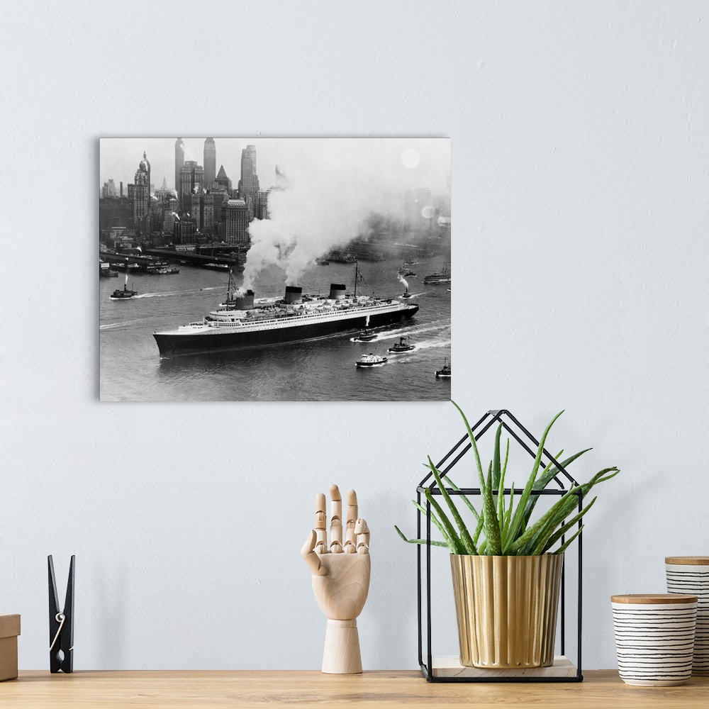 A bohemian room featuring Tugboats follow alongside the French turbine-electric ocean liner SS Normandie as it travels thro...