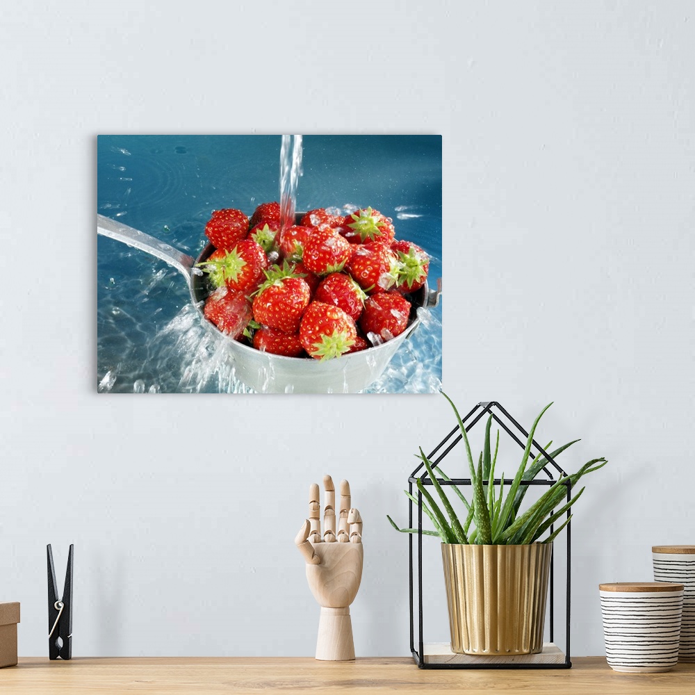 A bohemian room featuring Strawberries washing in sieve, close-up