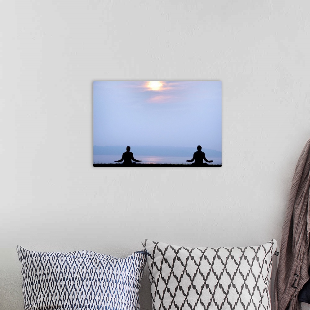A bohemian room featuring Two followers of the Falun Gong spiritual practice meditate at sunrise over the Atlantic ocean.
