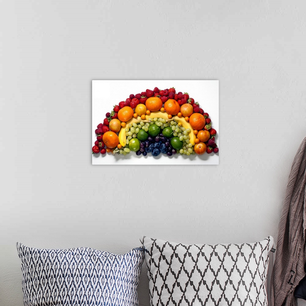 A bohemian room featuring Various fruits arranged into the shape of a rainbow