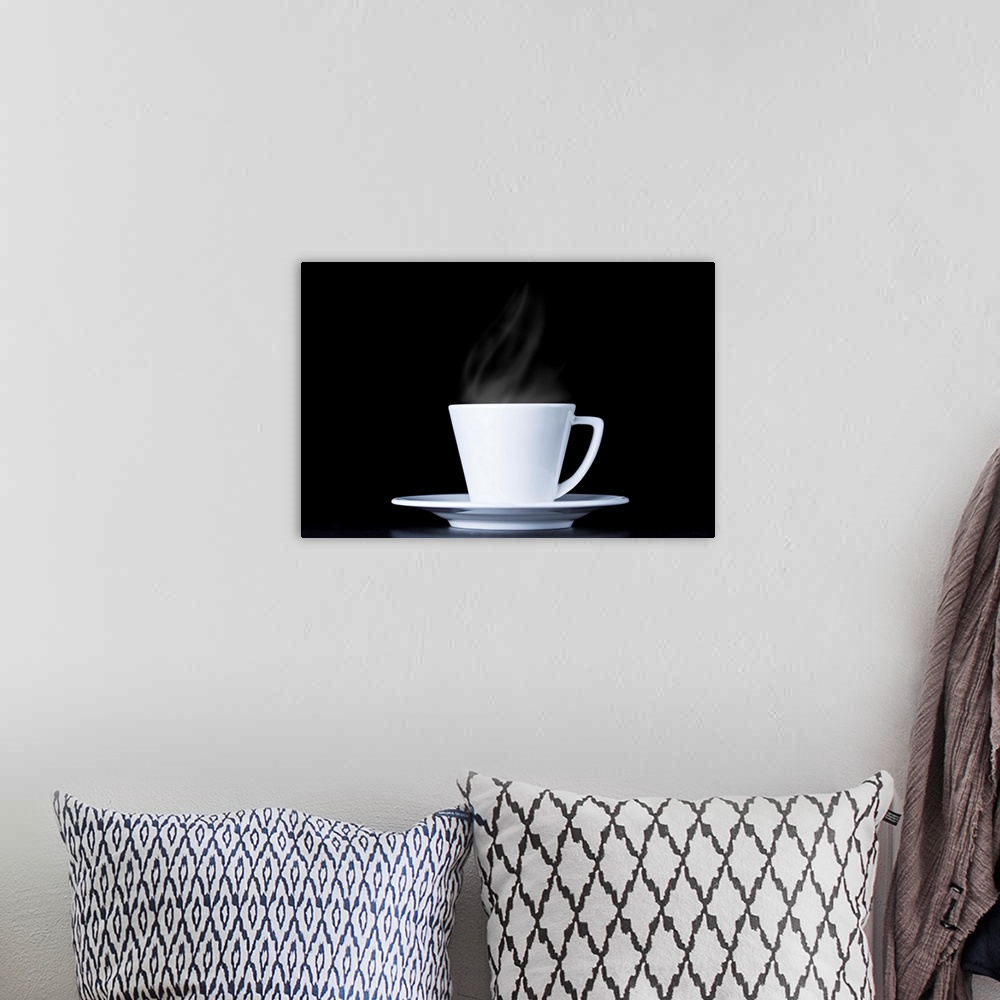 A bohemian room featuring White coffee cup and steam on black background