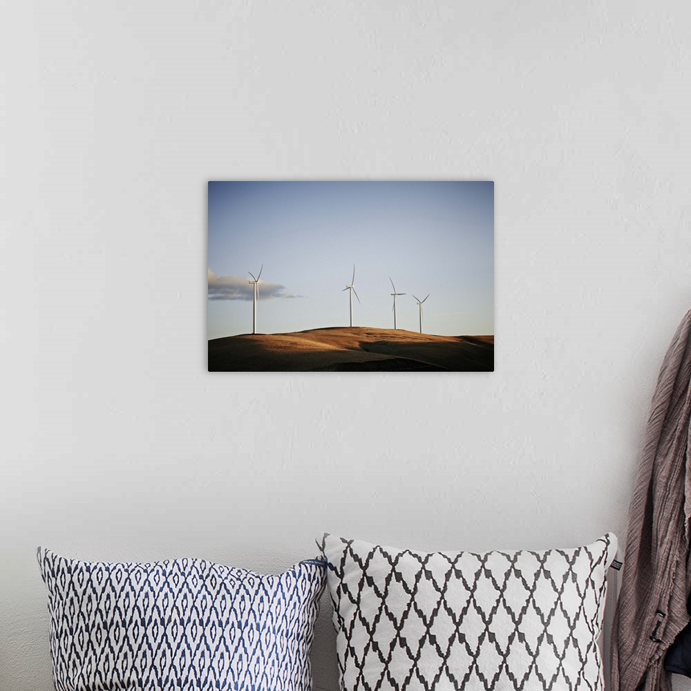 A bohemian room featuring Windmills on hill at sunset