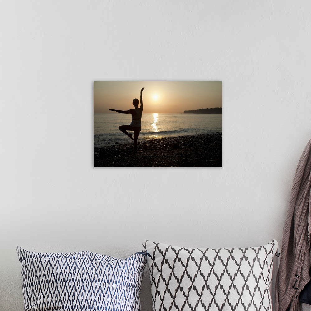 A bohemian room featuring Woman practicing ballet pose on the beach, sunrise
