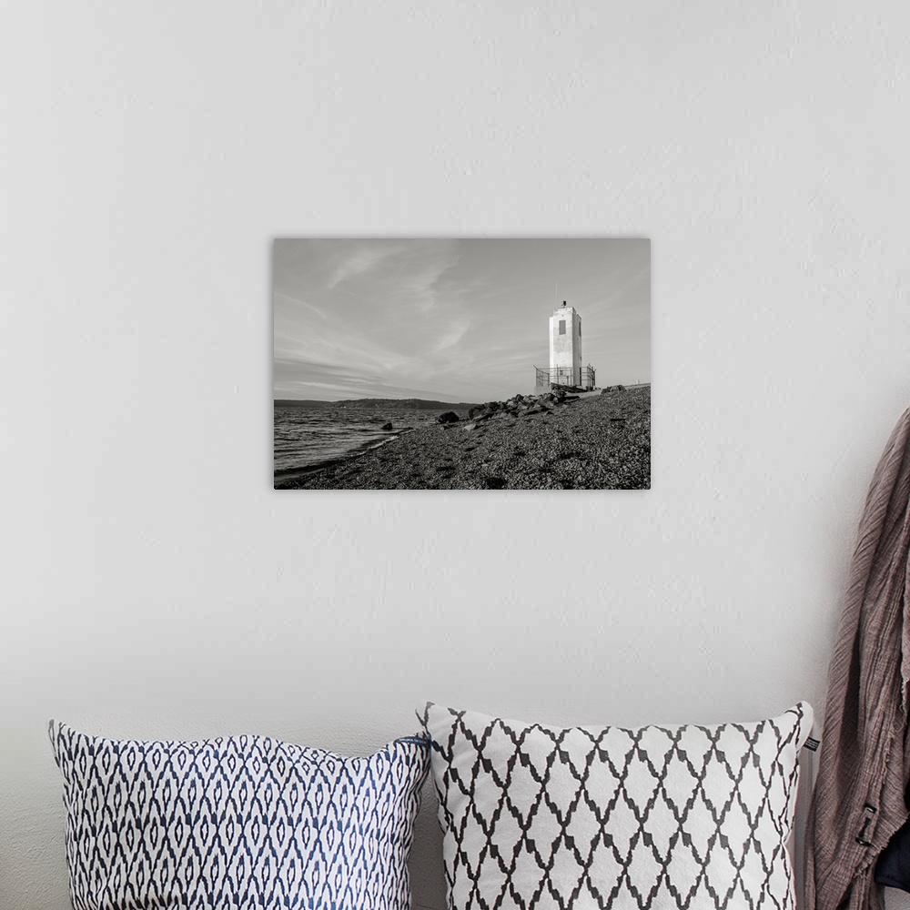 A bohemian room featuring A black and white photograph of the Puget Sound and lighthouse at Browns Point, Washington.