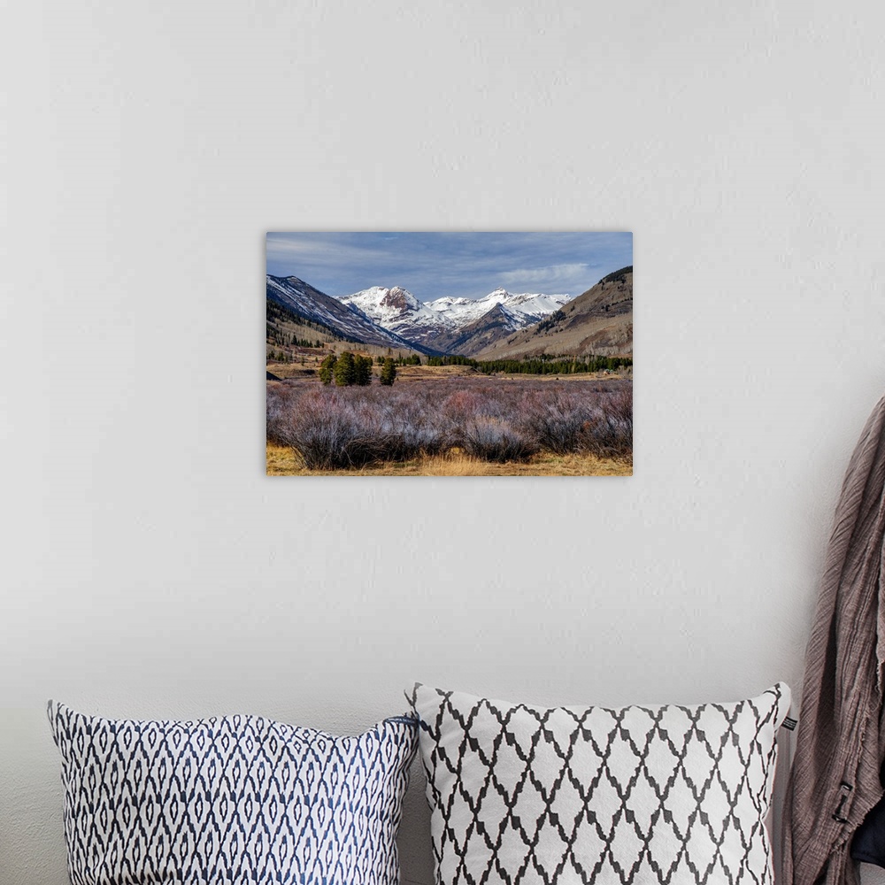 A bohemian room featuring The north view from Crested Butte, Colorado, features panoramic views of snow-capped mountains.