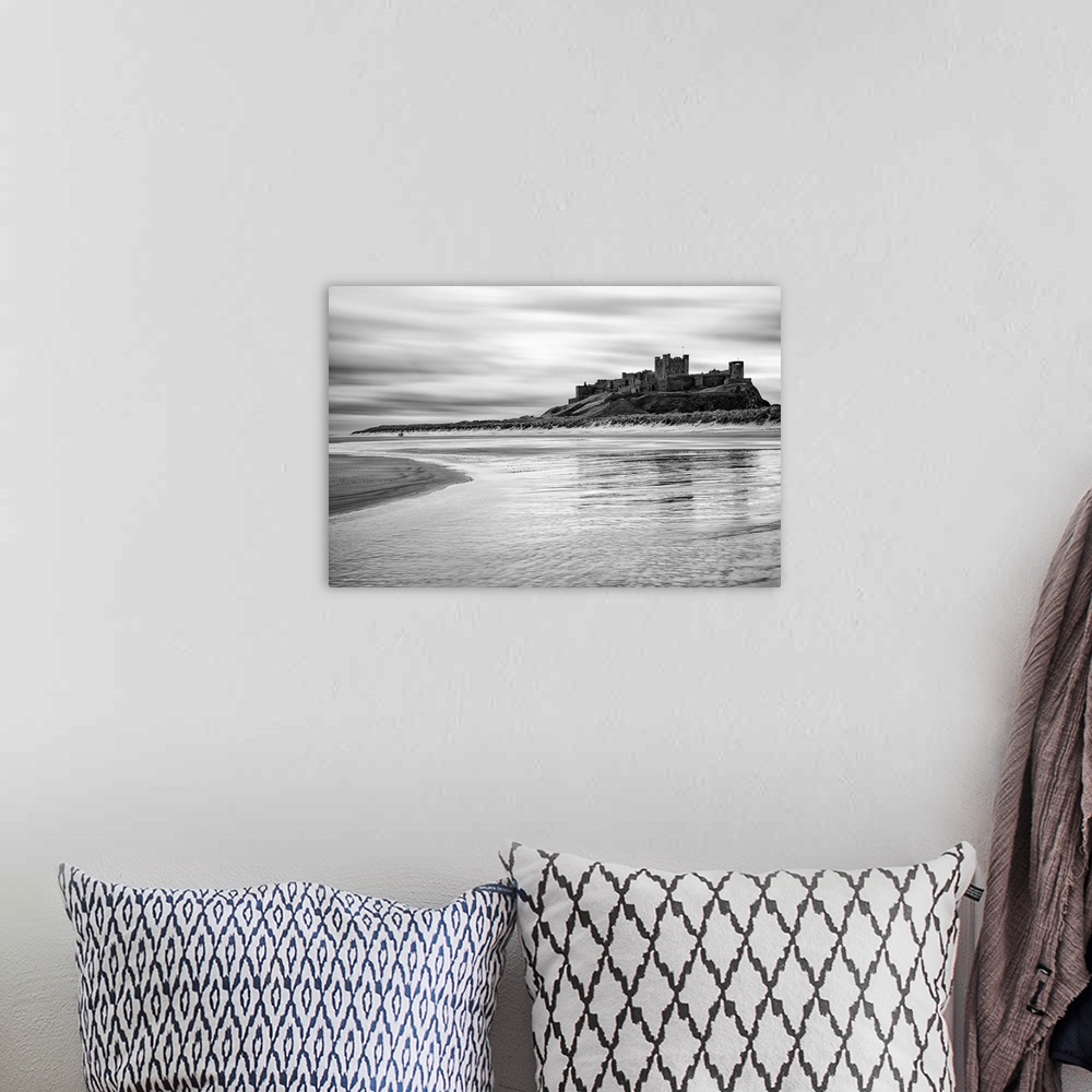 A bohemian room featuring Bamburgh castle and beach at low tide, Northumberland, UK