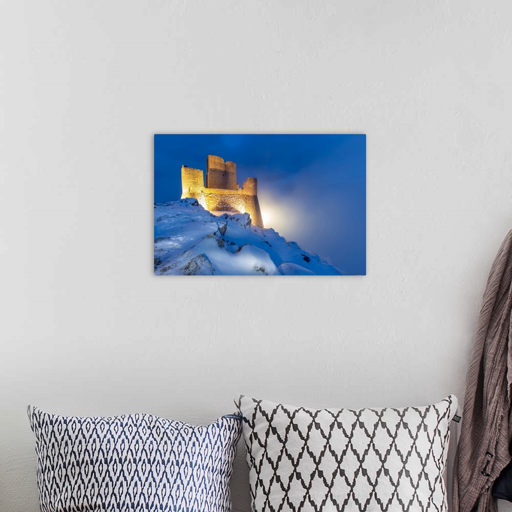 A bohemian room featuring Castle of Rocca Calascio in winter during the dusk-Europe, Italy, Abruzzo, Province of L'Aquila, ...