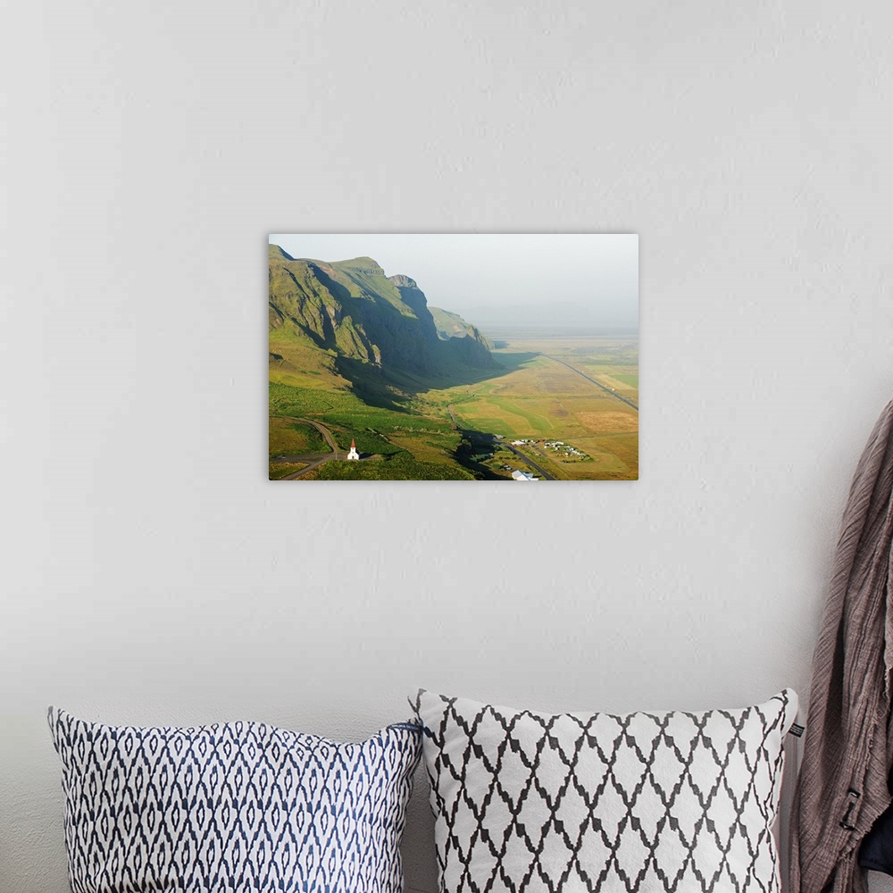 A bohemian room featuring Iceland, southern region, Vik, church and coastal scenery.