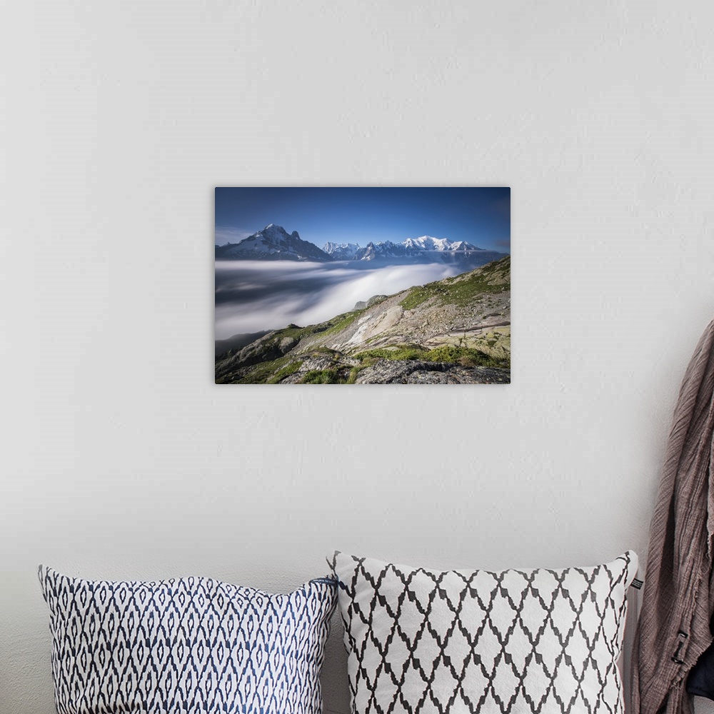 A bohemian room featuring Low clouds and mist frame the snowy peaks of Mont Blanc and Aiguille Verte, Chamonix, Haute Savoi...