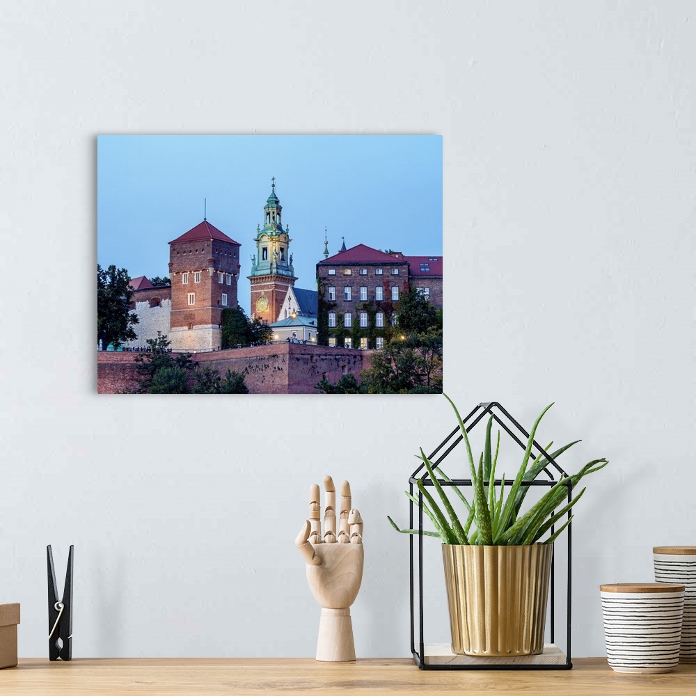 A bohemian room featuring Poland, Lesser Poland Voivodeship, Cracow, Wawel Royal Castle at twilight.