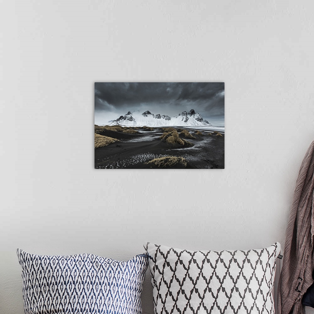A bohemian room featuring Stormy weather above Vestrahorn, depicted from Stokksens.