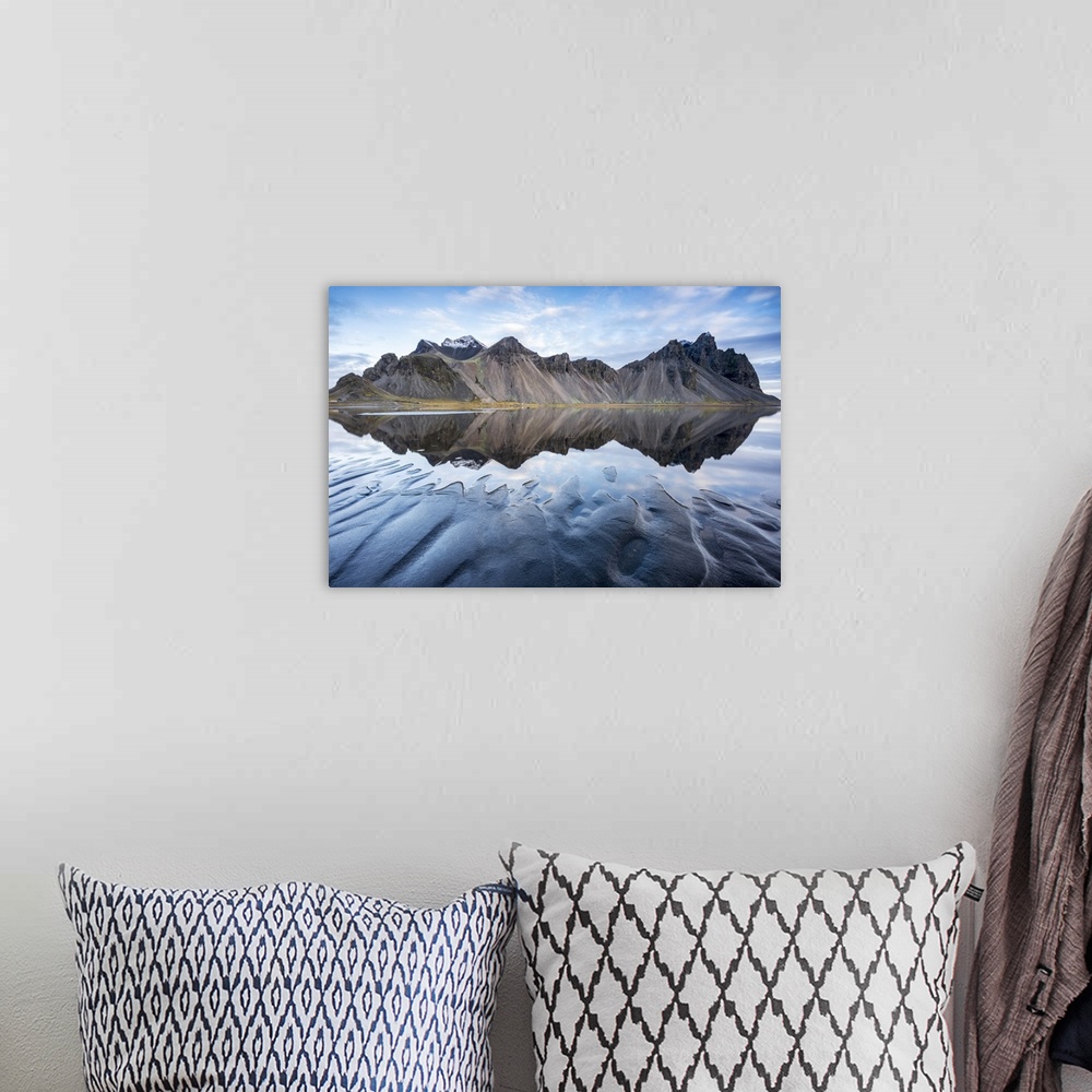 A bohemian room featuring The mountains reflect on the surface of the ocean. Stokksnes, Eastern Iceland, Europe.