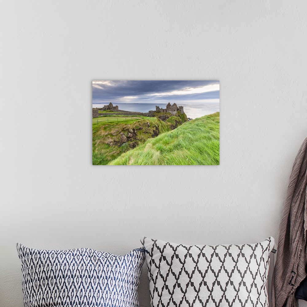 A bohemian room featuring View of the ruins of the Dunluce Castle. Bushmills, County Antrim, Ulster region, Northern Irelan...