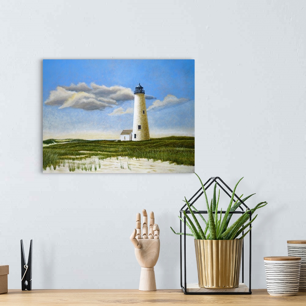 A bohemian room featuring Lighthouse on beach with cloudy sky.