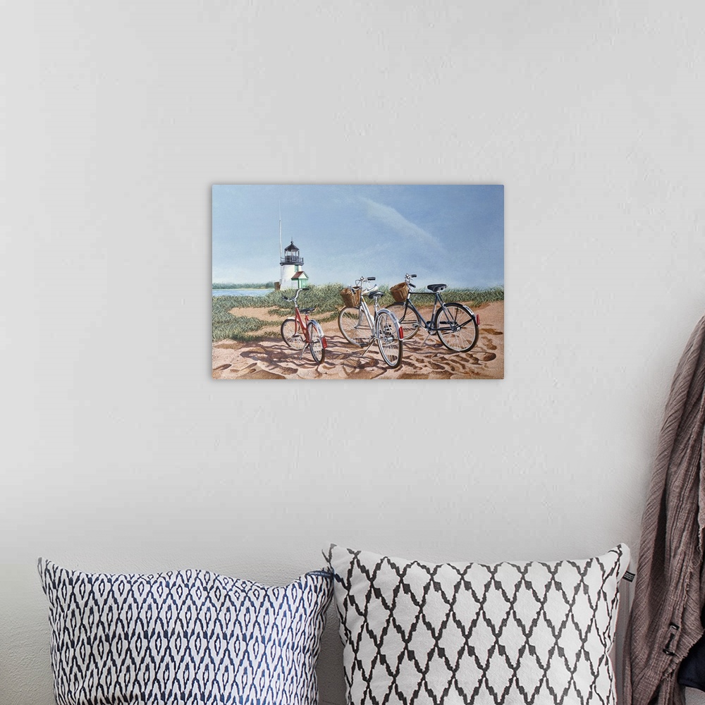 A bohemian room featuring Three bicycles on a beach with a lighthouse.