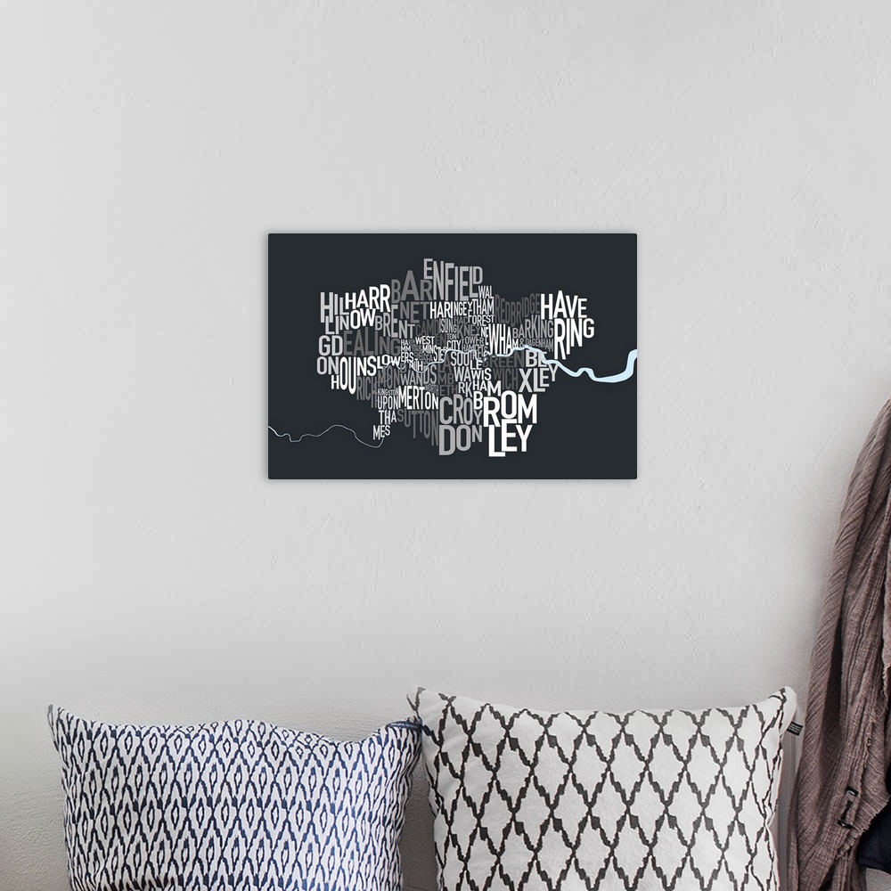 A bohemian room featuring A typographic map of the Boroughs of London, United Kingdom, in shades of grey on a charcoal grey...