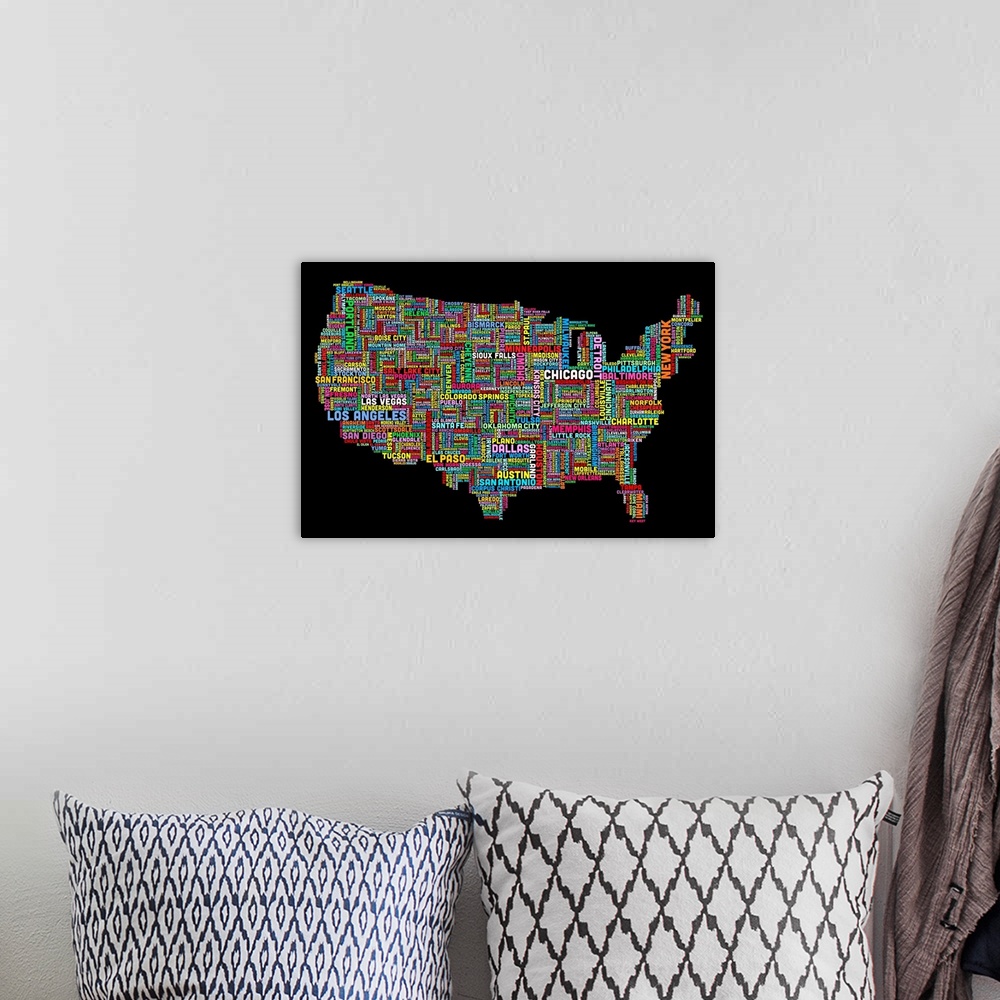 A bohemian room featuring Colorful map of America made of the names of each city that corresponds to its location.
