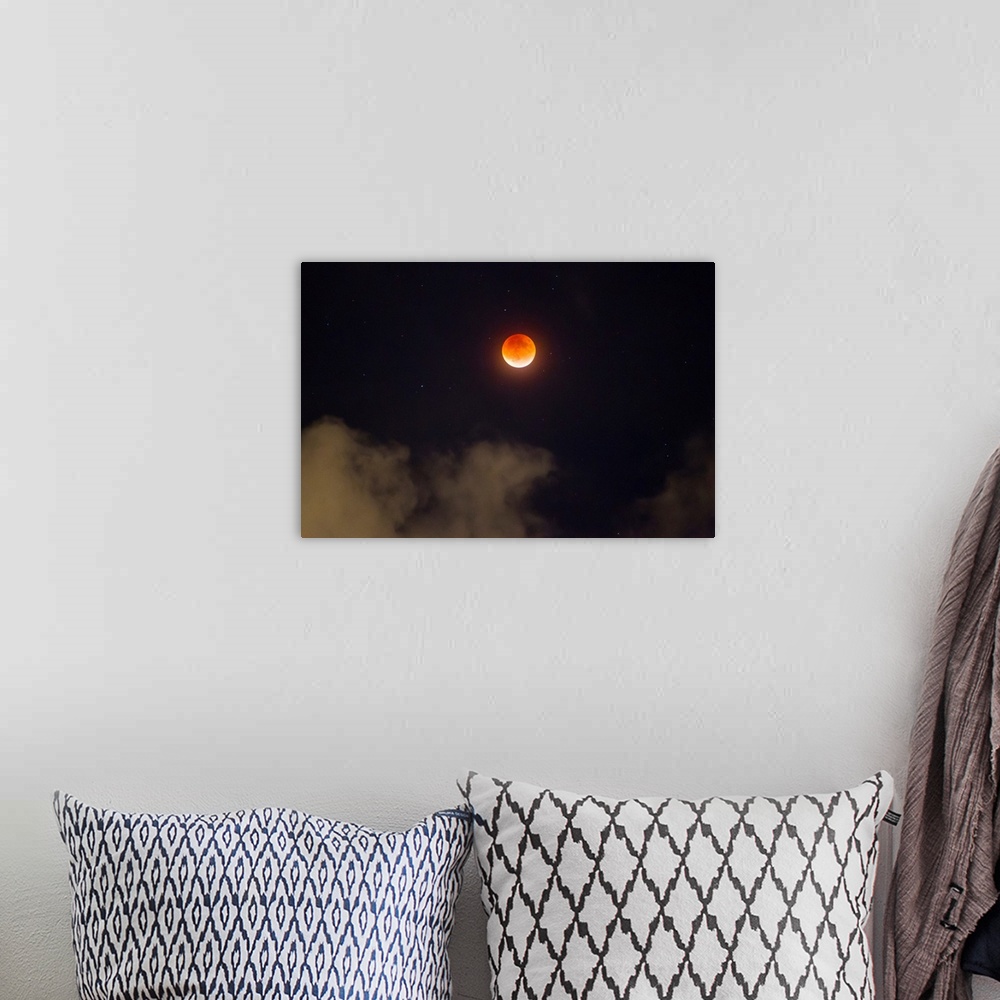A bohemian room featuring A break in the clouds reveals a rare lunar eclipse, also known as the super moon, or blood moon.