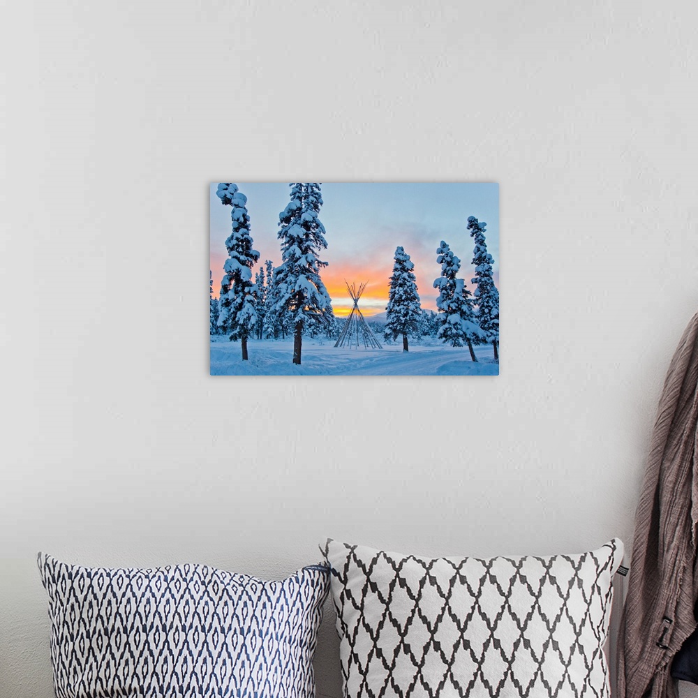 A bohemian room featuring Orange sky at sunset over snow-covered evergreens and a tee pee form.