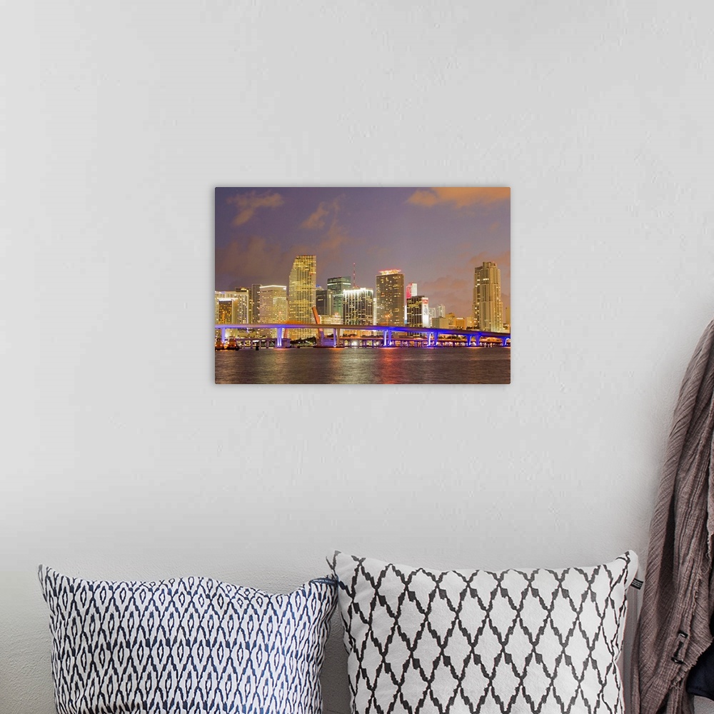 A bohemian room featuring The Miami causeway and skyline at night.