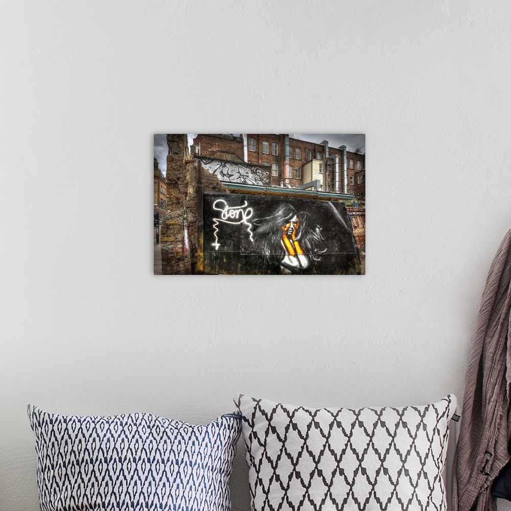 A bohemian room featuring Fine art photograph of a graffiti on the facade of a city building.