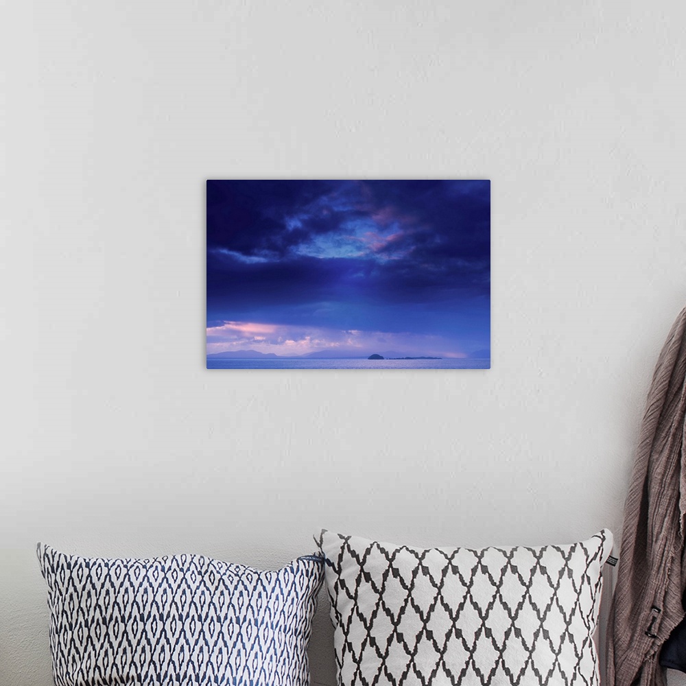 A bohemian room featuring Fine art photo of a deep blue sky with storm clouds over the ocean.