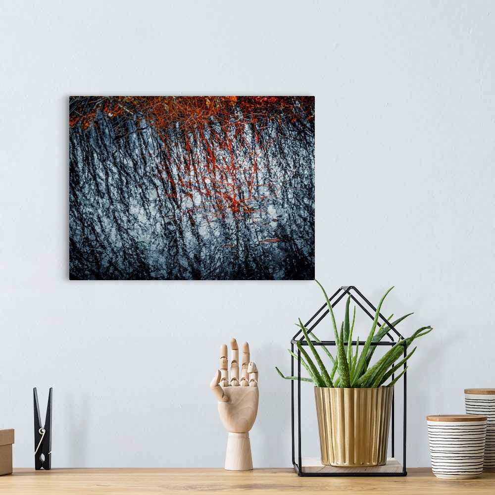 A bohemian room featuring Abstract photograph with rough textures in black, red, and white.