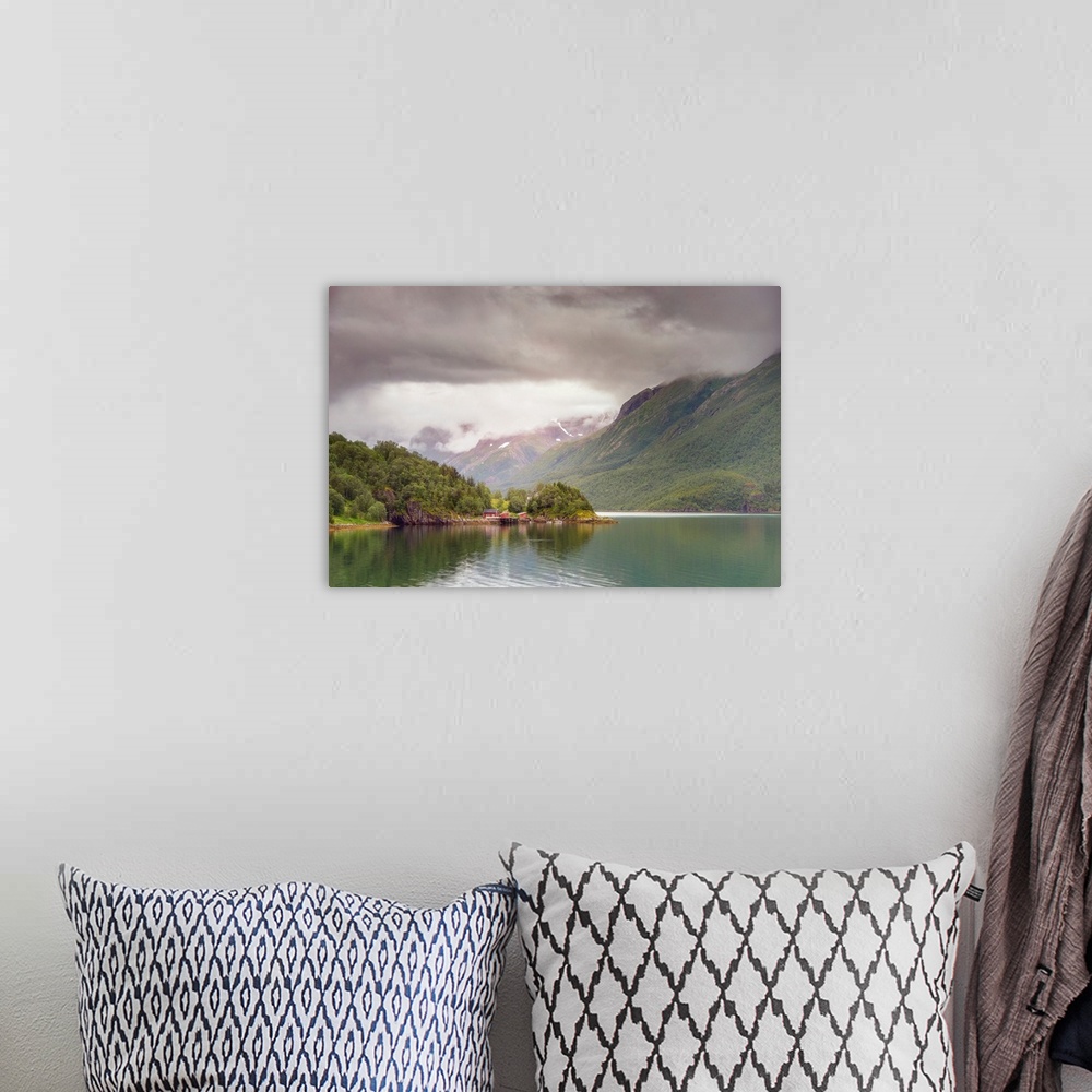 A bohemian room featuring A Norwegian mountain valley under dark dramatic clouds.