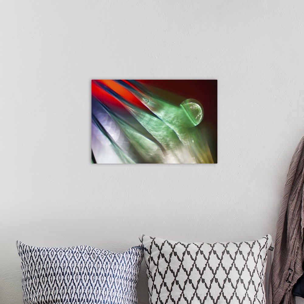 A bohemian room featuring Abstract photograph of green ridges against red and purple.
