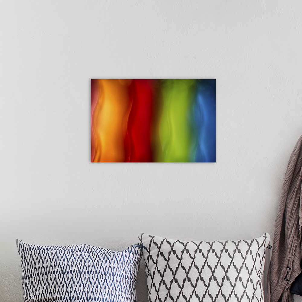 A bohemian room featuring Abstract photograph in orange, red, green, and blue vertical layers.