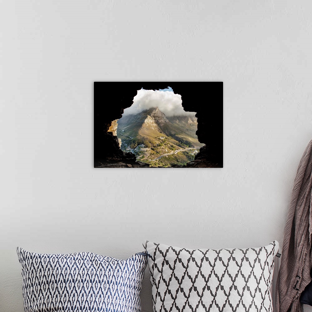 A bohemian room featuring A key hole view of a mountain from the inside of a cave.
