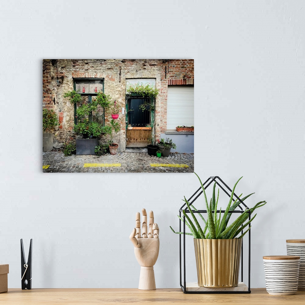 A bohemian room featuring A photo of brick building covered in plants from a street view.