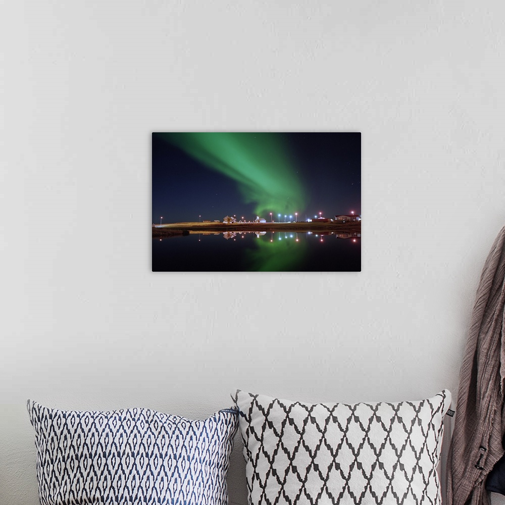 A bohemian room featuring Aurora Borealis over a town, Njardvik, Iceland