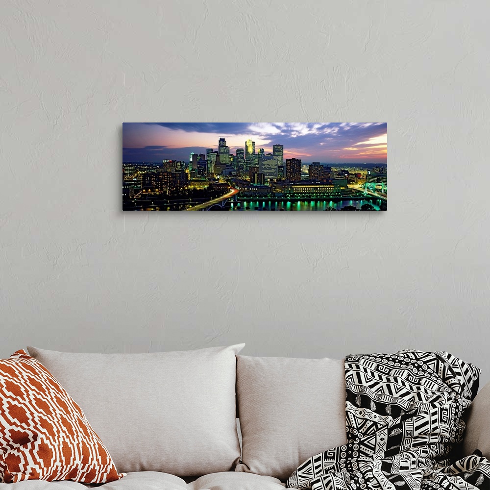 A bohemian room featuring Wide angle panoramic photograph of Minneapolis skyscrapers at night, beneath a colorful sunset.