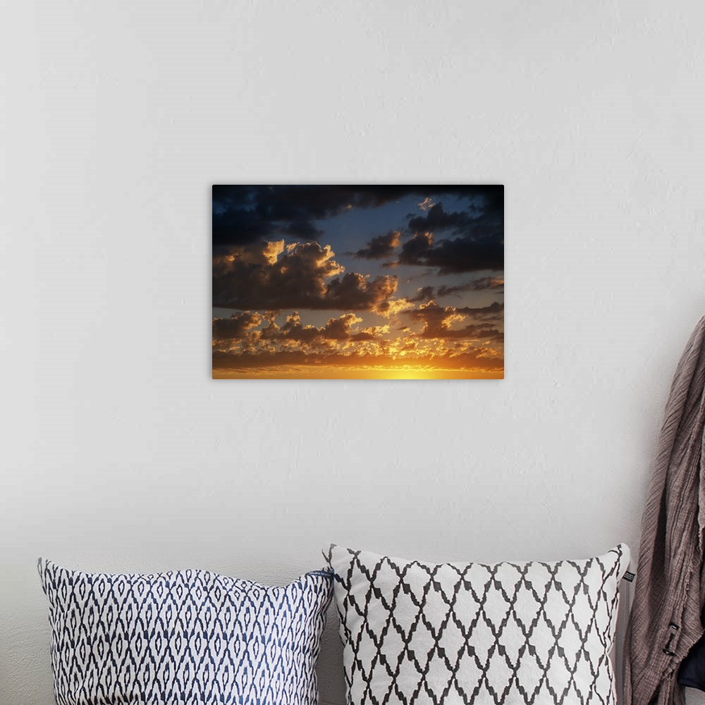 A bohemian room featuring Horizontal photograph on a large canvas of a vibrant, golden sunset beneath a darkening sky full ...