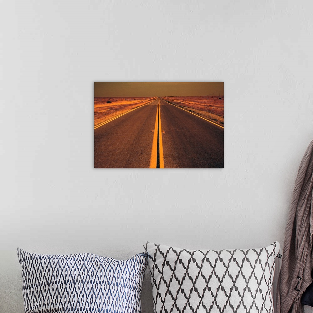A bohemian room featuring Distance view of empty road in desert at evening