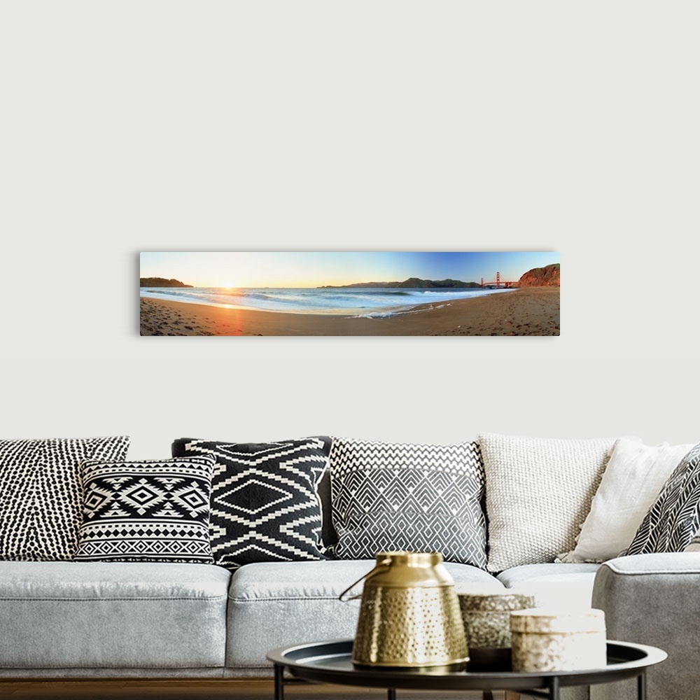 A bohemian room featuring Long panoramic photo of a beach with the golden gate bride on the far right and the setting sun o...