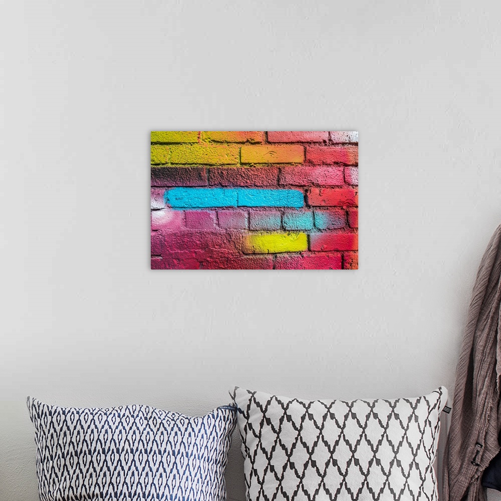A bohemian room featuring Multi-colored brick wall.