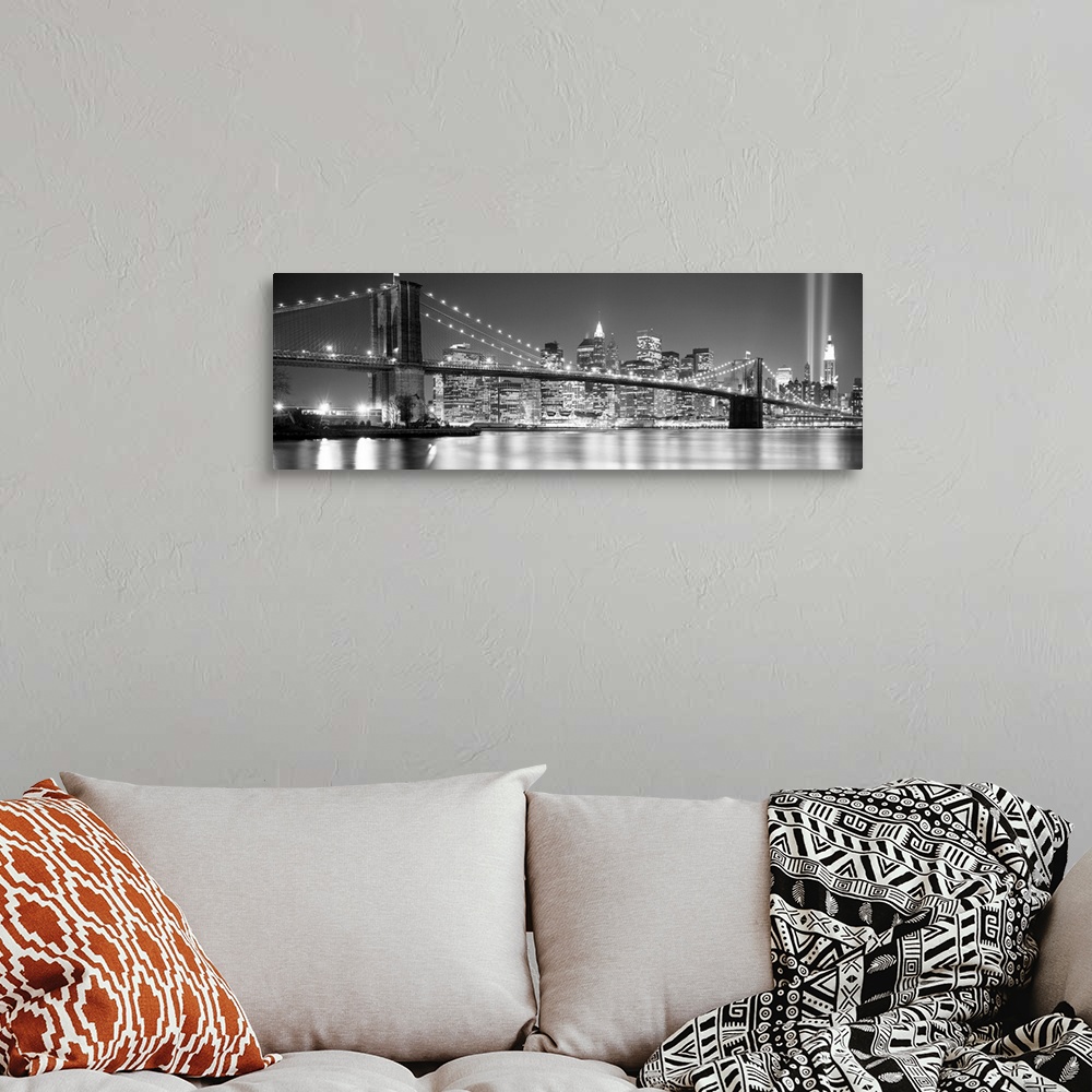A bohemian room featuring A panoramic landscape photo taken after 2001 of Manhattan and Brooklyn Bridge shining bright over...