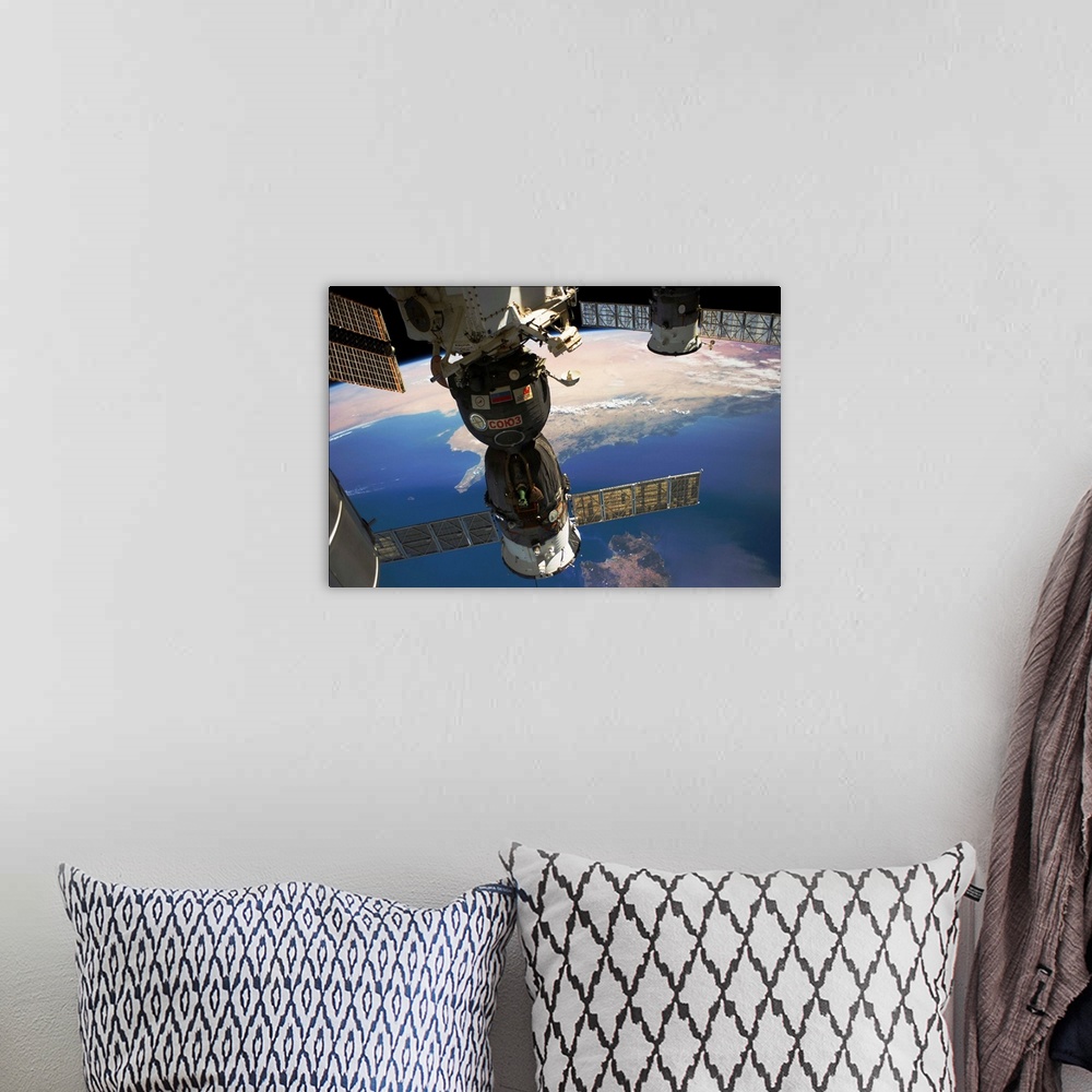 A bohemian room featuring Satellite in space with view of Italy and Africa on Earth
