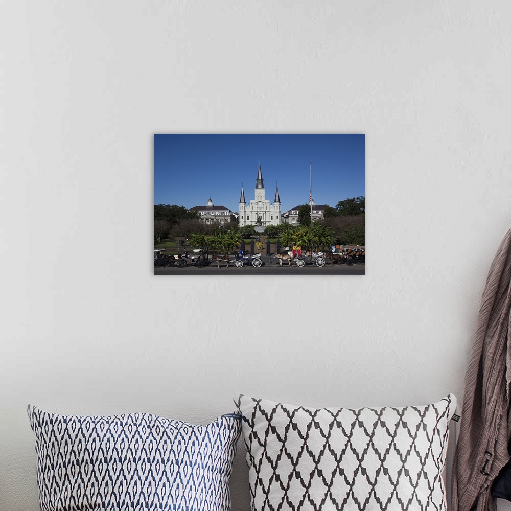 A bohemian room featuring Several mule-drawn carriages in front of the St. Louis Cathedral in New Orleans, Louisiana.
