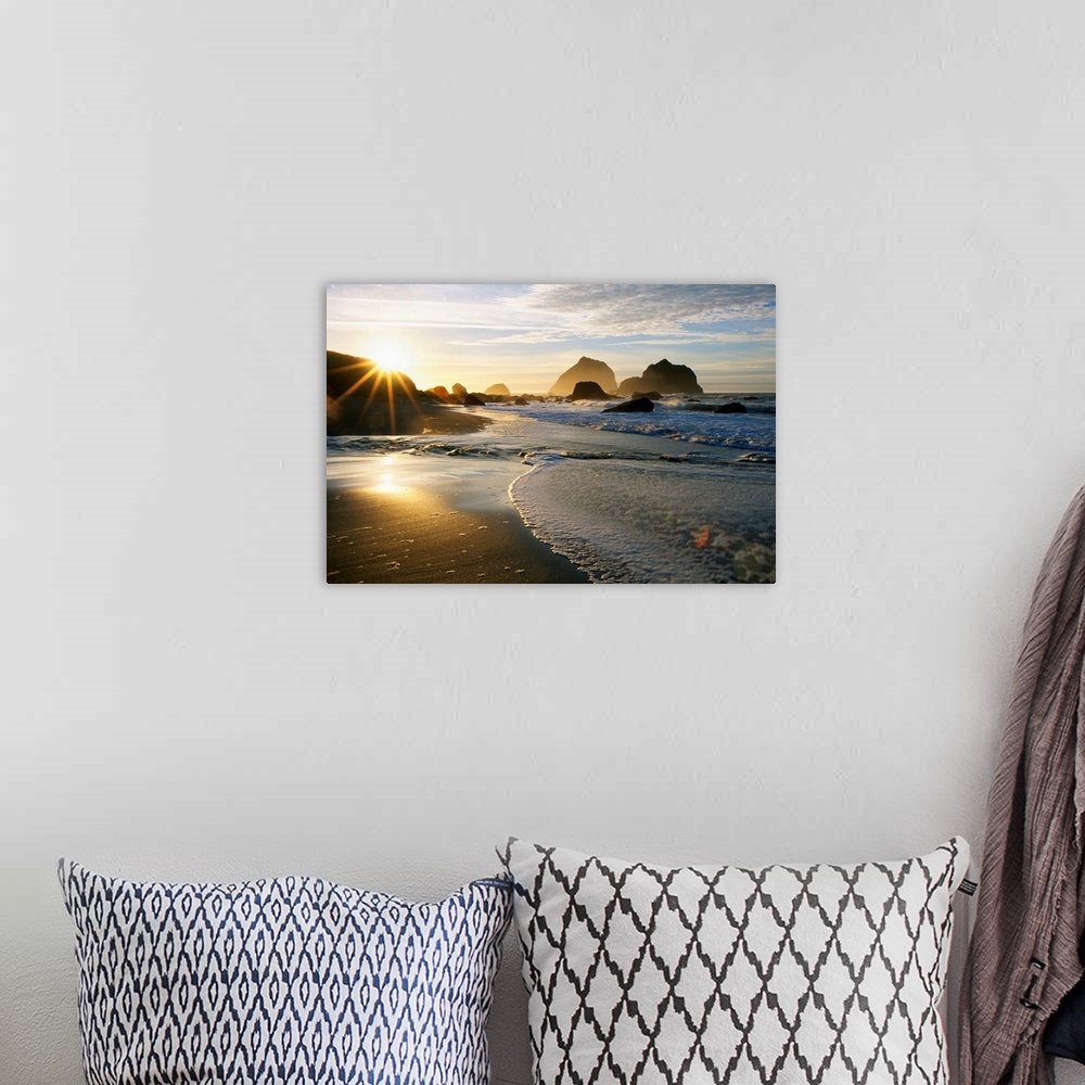 A bohemian room featuring Panoramic photograph displaying a sunset over an ocean and sandy beach.  In the background you ca...