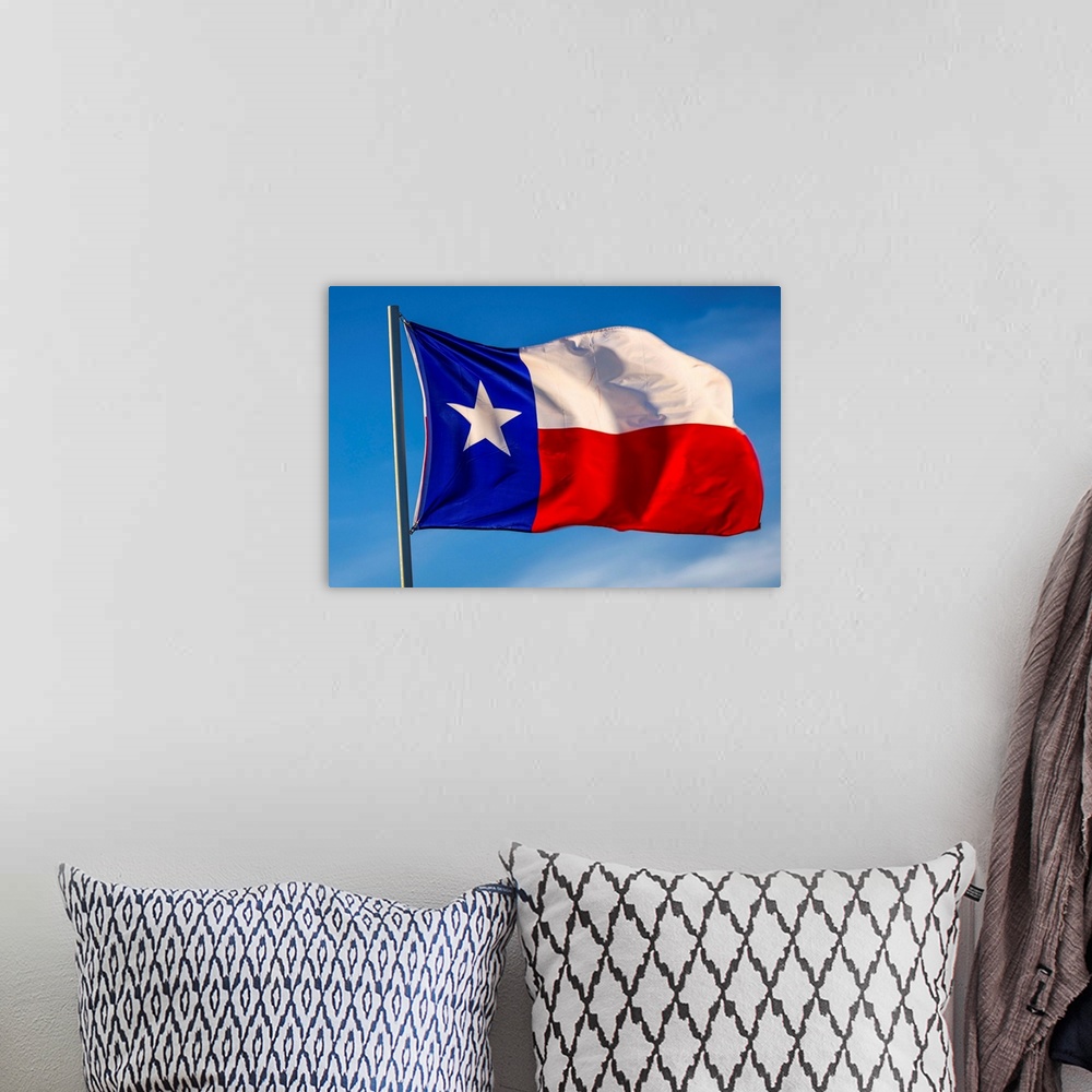 A bohemian room featuring Texas "lone star" flag stands out against a cloudless blue sky, houston, texas.