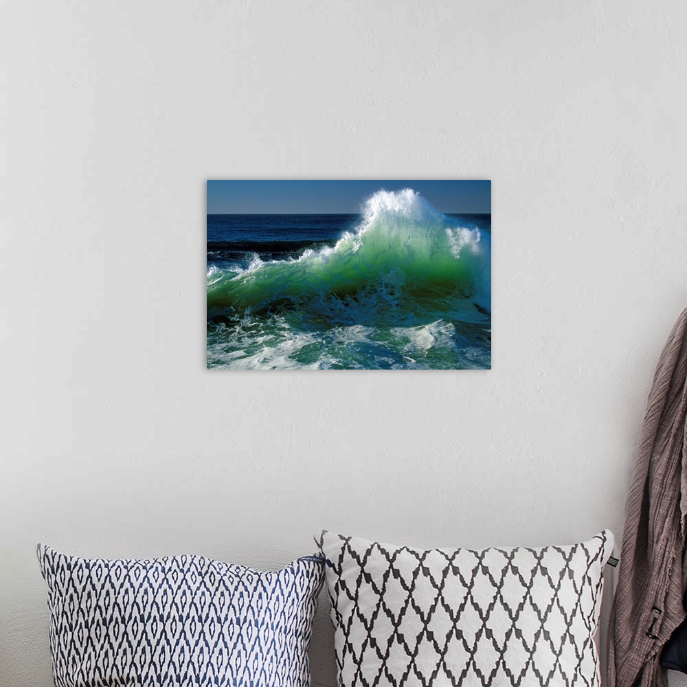 A bohemian room featuring This wall art for the office or home is a landscape photograph of a wave breaking near the shore.