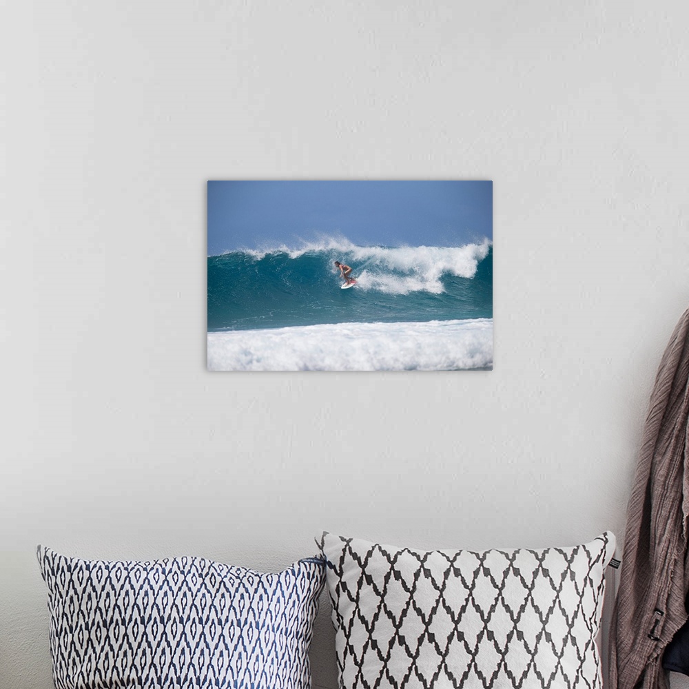 A bohemian room featuring Woman surfing down a wave on beach, Hawaii, USA