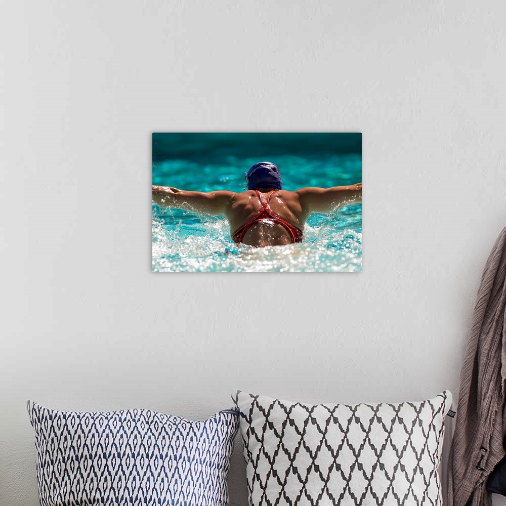A bohemian room featuring Rear view of a woman swimming the butterfly stroke in a swimming pool, bainbridge island, washing...