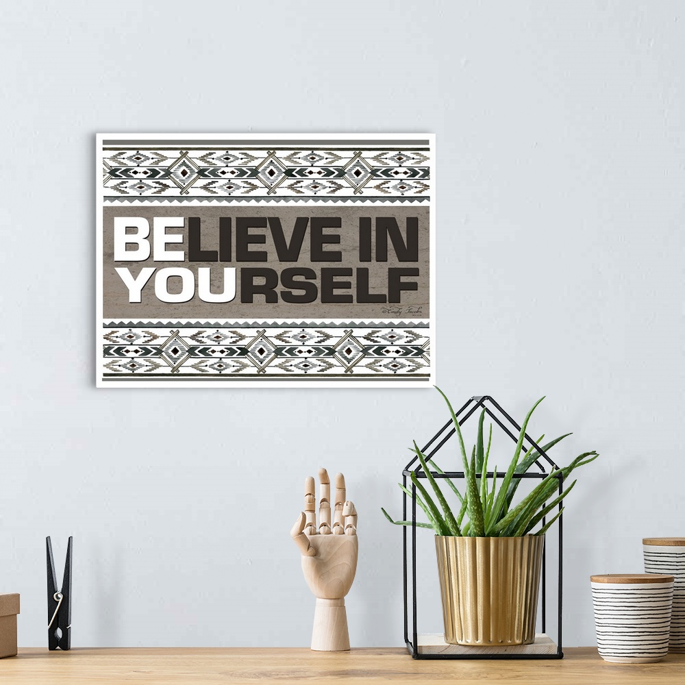 A bohemian room featuring Decorative artwork featuring geometric southwestern designs and the words: Believe in yourself/Be...