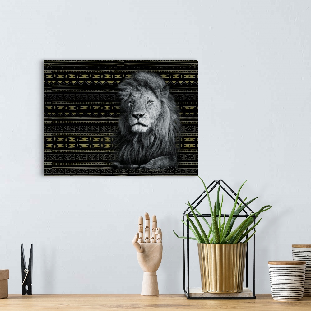 A bohemian room featuring Artwork of a resting lion, with a gold and black tribal pattern.
